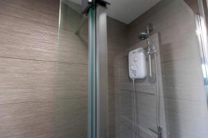 a shower with a shower head in a bathroom at Jameson Lodge in Hartlepool