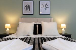 a bedroom with a bed with two lamps at Jameson Lodge in Hartlepool +19 photos