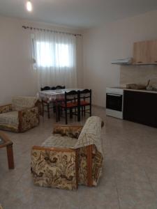 a living room with a couch and a table and a kitchen at Gold Crest House Vrasna in Nea Vrasna