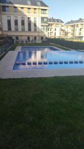 a large swimming pool in front of a building at Duplex Playa de Foz in Foz