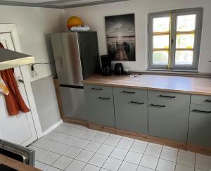 a kitchen with a counter and a refrigerator at Cottage mit Garten in Michendorf