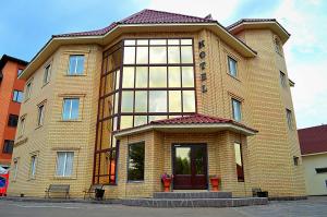 a large brick building with a large window at Hotel Gloria Standard in Borovoye