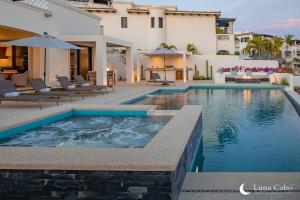a swimming pool in front of a villa at Luxe Oceanview Villa with Pool Hot Tub BBQ and Fire Pit in San José del Cabo