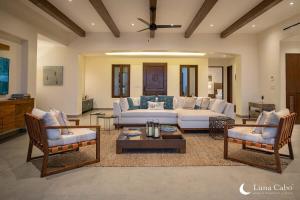 a living room with a white couch and two chairs at Luxe Oceanview Villa with Pool Hot Tub BBQ and Fire Pit in San José del Cabo