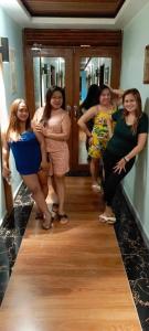 a group of women standing in front of a mirror at GBU Loboc River Guesthouse in Loboc