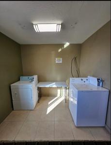 a laundry room with a washer and dryer in it at Super 8 by Wyndham Holbrook in Holbrook