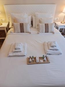 a bedroom with a white bed with a tray on it at Casa del Sol in Manilva
