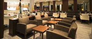a restaurant with a row of chairs and tables at Fiesta Residences Boutique Hotel and Serviced Apartments. in Accra