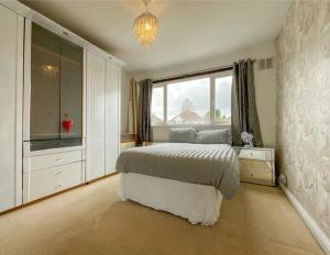 um quarto com uma cama e uma grande janela em Hardwick house em Streetly