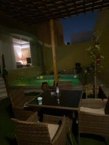 a room with a table and chairs and a pool at Elegant Apartment - Private Pool & Garden Views in Riyadh +13 photos