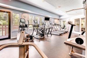 a gym with a bunch of treadmills and ellipticals at Sunrise Mountain Village in Killington