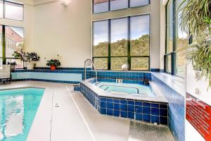 a large swimming pool with blue tile in a house at Sunrise Mountain Village in Killington