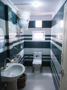 a bathroom with blue and white striped walls and a toilet at Homestay Darjeeling in Darjeeling