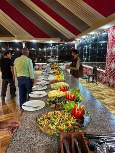 a buffet line with plates of food on a table at Wadi Rum palace in Wadi Rum