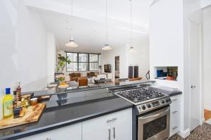 a kitchen with a stove top oven in a room at Amazing 1300sf Loft By Union Sq in New York