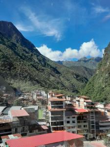 a view of a city with mountains in the background at Fenix Hotel Machupicchu by Bruno's in Machu Picchu