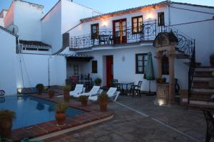 a house with a swimming pool in front of it at Apartamentos La Ciudad in Ronda