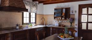 a kitchen with a table with a bowl of fruit on it at AKASHA in Puerto del Rosario