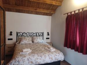 een slaapkamer met een bed met twee handdoeken erop bij El Freginal in Olocau del Rey