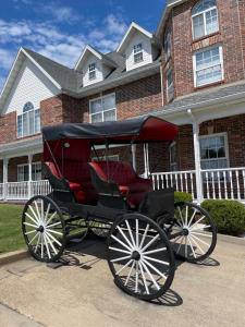a horse drawn carriage parked in front of a house at Carriage House Inn in Branson