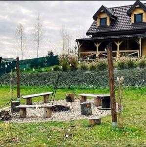 a park with a picnic table in front of a house at Domek pod Dębami Bogaczewo in Bogaczewo