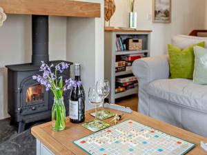a living room with a table with wine glasses and a fireplace at 1 Bed in South Molton 3.1 miles SE 91153 in George Nympton