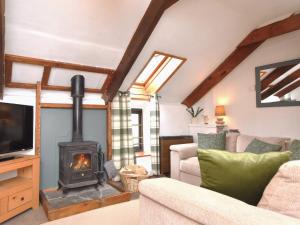 a living room with a wood stove at 2 Bed in Bude NPHON in Poundstock