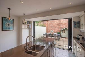 a kitchen with a sink and a large window at Station House in Marlow