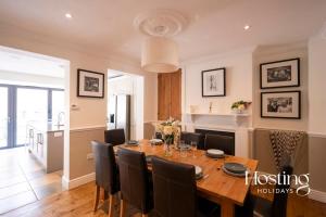 a dining room with a wooden table and chairs at Station House in Marlow