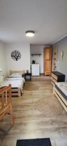 a bedroom with a bed and wooden floors at MARINKA Grzybowo in Grzybowo