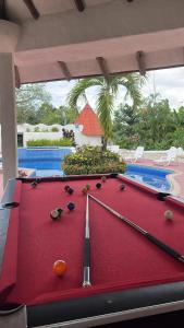 a pool table in front of a swimming pool at Mia Nueva Gorgona in Nueva Gorgona