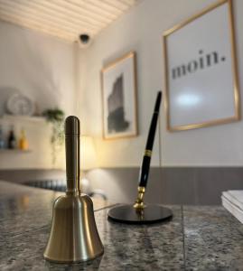 a pen sitting on top of a counter next to a microphone at Hotel Kieler Hof - Hamburg Central Station in Hamburg