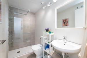 a bathroom with a sink and a toilet and a shower at DREAMY BEACH PENTHOUSE in Torre de Benagalbón