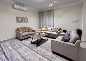 a living room with two couches and a coffee table at شقق نسج المسكن دخول ذاتي شمال الرياض in Riyadh