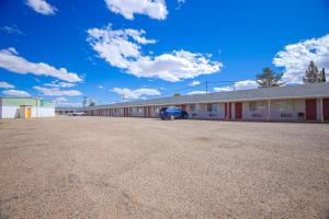 um parque de estacionamento vazio em frente a um edifício em Holiday Motel, Lordsburg By OYO em Lordsburg