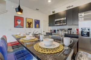 a kitchen with a table with plates and wine glasses at Kissimmee Modern 3BR Home With a pool & Close to Beach in Kissimmee