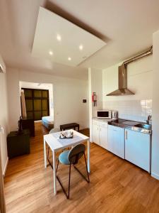 a kitchen and living room with a table and chairs at VALE MAR Guest in Ribeira Brava