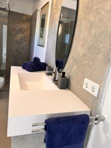 a bathroom with a sink and a mirror at Secret Garden Chalet No. 1 in San Pietro in Bevagna