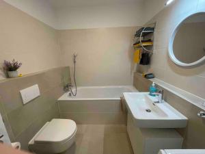 a bathroom with a sink and a toilet and a tub at Magnolia in Trnávka +33 photos