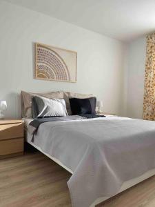 a bedroom with a large bed and a wooden floor at Magnolia in Trnávka