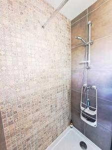 W łazience znajduje się prysznic i biała wanna. w obiekcie Magnifique appartement au coeur des volcans w mieście Blanzat