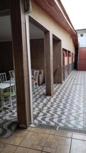 a building with a patio with tables and chairs at Pousada Econômica in Uberlândia