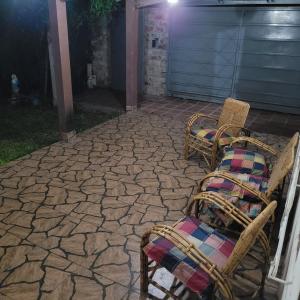 zwei Stühle, die nachts auf einer Terrasse sitzen in der Unterkunft Pequinos in Strobel