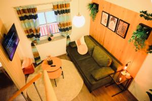 a living room with a couch and a table at Galeriewohnung Vierseithof in Eging