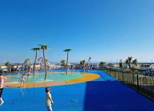 a group of people playing in a water park at Luxury Romantic 2 Bedroom Caravan Trecco Bay in Newton