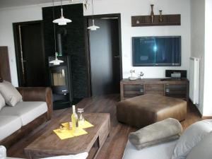 ein Wohnzimmer mit einem Sofa und einem Tisch in der Unterkunft Ferienwohnung in Sellin mit Grill, Terrasse und Garten in Ostseebad Sellin