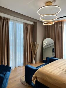a bedroom with a blue bed and a mirror at Enjoy Luxury Condo with Sea View in Abu Dhabi
