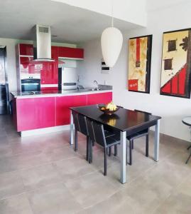a kitchen with a black table and red cabinets at Nuevo Vallarta Condo 2Bed 2Bath in Nuevo Vallarta 