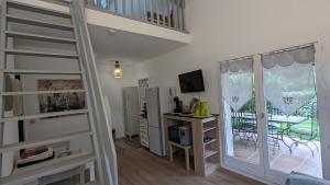 a room with a staircase with a desk and a sliding glass door at MAISONNETTE au CALME avec CLIMATISATION PARKING JARDIN CADRE CAMPAGNE plages à pieds in Bandol