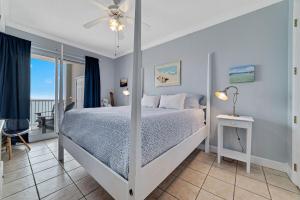 a bedroom with a bed with a ceiling fan at Island Royale 701 in Gulf Shores +41 photos